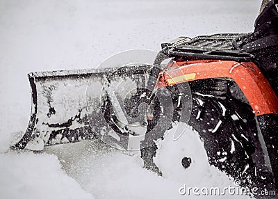 ATV in the snow. Cleaning the streets of snow with a tractor Stock Photo