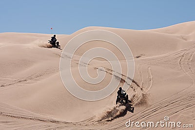 ATVs hopping the dunes Stock Photo