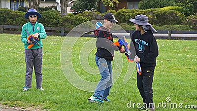 Auckland, New Zealand, 10th of Nov 2019, adults and kids playing nerf gun together at an outdoor children playground Editorial Stock Photo