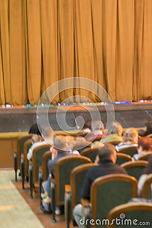 Audience in Theater. closed stage curtain in a theater. blurry. vertical photo Stock Photo