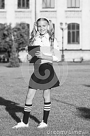 Audio book concept. Listening school book. Digital technologies for learning. Elearning and modern methods. Girl cute Stock Photo