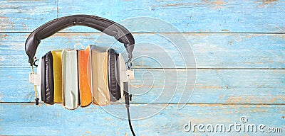 Audio book concept, with row of books, headphones, Stock Photo