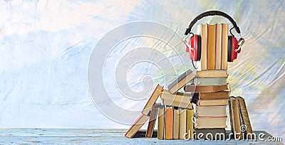 audio book concept with stack of books and vintage red headphone on blue background,good copy space Stock Photo