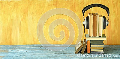 Audio book concept with stacks of books and vintage headphones,literature,entertainment,education, copy space Stock Photo