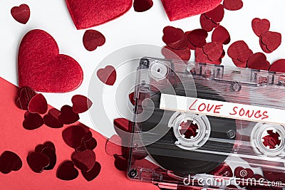 Audio cassette tape on red backgound with fabric heart Stock Photo