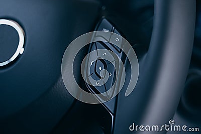 Audio control buttons on the steering wheel of a modern car Stock Photo