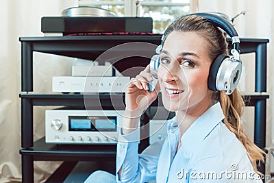 Audiophile woman enjoying music in her home Stock Photo