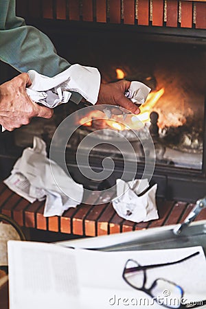 Businessman destroying important documents from case in firepla Stock Photo