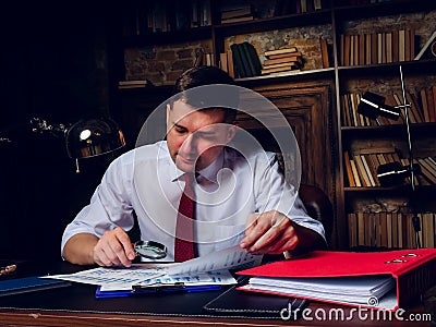 The auditor does audit of the company financial statements late at night. Stock Photo