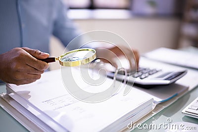 Auditor Using Magnifying Glass For Audit Stock Photo