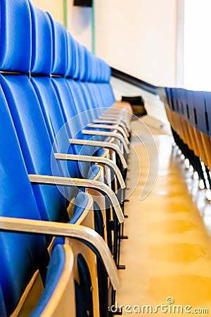 Auditorium, row of blue seats, perspective of a student. Rows of chairs with desks on an empty vacant lecture hall, interior. Stock Photo