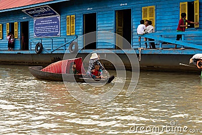 Aug : 29 : 2018 - SIEM REAP, CAMBODIA - Mother taking children to School by boat in floating village on Tonle Sap Lake. Editorial Stock Photo