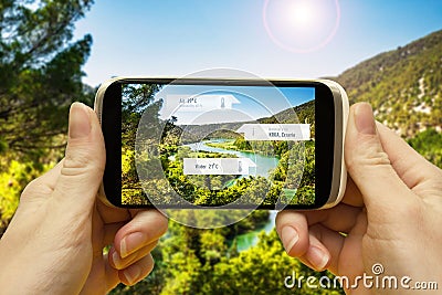 Augmented reality applications for travel and leisure. Hand with a smartphone app A / R on-screen information about the place of Stock Photo