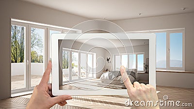 Augmented reality concept. Hand holding tablet with AR application used to simulate furniture and design products in empty Stock Photo