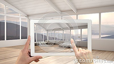 Augmented reality concept. Hand holding tablet with AR application used to simulate furniture and design products in empty Stock Photo