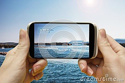 Augmented reality in the journey. Hand smartphone app to use AR, to check the relevant information about the spaces around the Stock Photo
