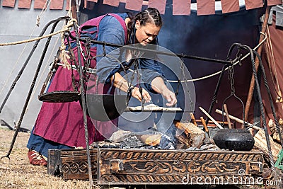 14 August 2022, A Big Baker Woman making bread in a Medieval Event `Viagem Medieval em Terra de Santa Maria`. Editorial Stock Photo