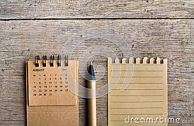 August. Calendar sheet on wooden background. Stock Photo