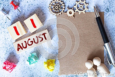 August 11 - Daily colorful Calendar with Block Notes and Pencil on wood table background Stock Photo