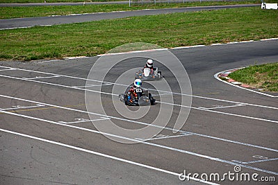 Two kart racers in a corner fighting each other for position Editorial Stock Photo