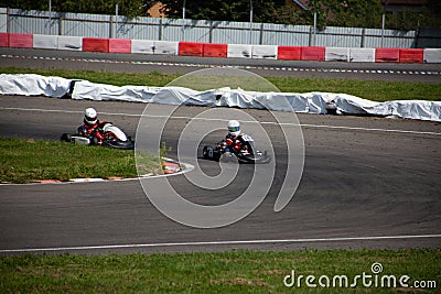 Two kart racers in a corner fighting each other for position in a race Editorial Stock Photo