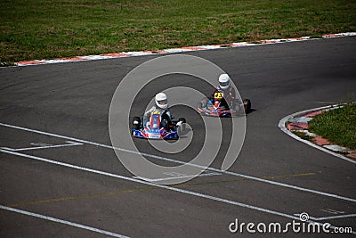 Two kart racers in a corner fighting each other for position Editorial Stock Photo