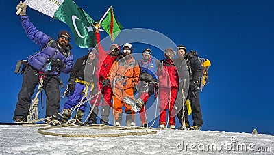 August 30, 2010 at 8:30 a.m. team of climbers and porters together with the first Muslim woman Ismaili from Pakistan climbs Editorial Stock Photo