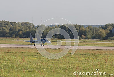 29 AUGUST 2019 MOSCOW, RUSSIA: Reactive fighter jet is gaining speed on the runway and getting ready to take off Editorial Stock Photo