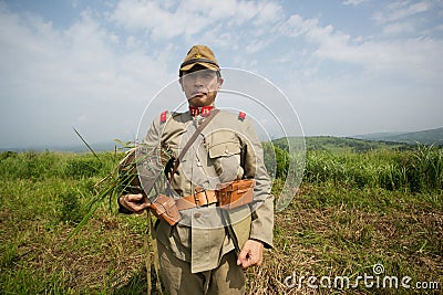 Japanese soldiers-reenactors reproduce the attack on the Soviet army during the Second World War Editorial Stock Photo