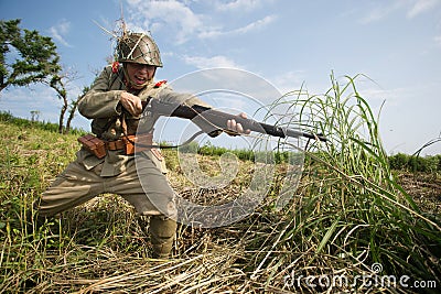 Japanese soldiers-reenactors reproduce the attack on the Soviet army during the Second World War Editorial Stock Photo