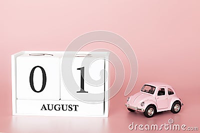 August 01st. Day 1 of month. Calendar cube on modern pink background with car Stock Photo