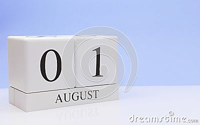 August 01st. Day 1 of month, daily calendar on white table with reflection, with light blue background. Summer time, empty space Stock Photo