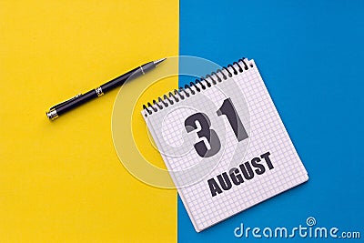 August 31th. Day of 31 month, calendar date. A notebook with a spiral and a pen lies on a yellow-blue background, flat lay, copy Stock Photo