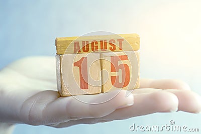 august 15th. Day 15 of month,Handmade wood cube with date month and day on female palm summer month, day of the year concept Stock Photo