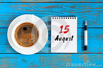August 15th. Day 15 of month, loose-leaf calendar on blue background with morning coffee cup. Summer time. Top view Stock Photo