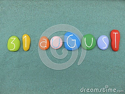 31 August, calendar date composed with multi colored stones over green sand Stock Photo