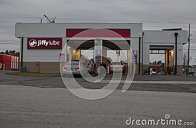 Cars in line at Jiffy Lube on a cloudy day Editorial Stock Photo