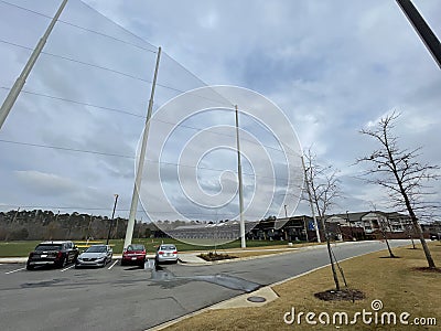 Golf range on Cabela parkway cloudy day cars and tall fence Editorial Stock Photo