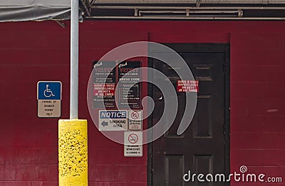 Many signs on a nightclub entrance door Editorial Stock Photo