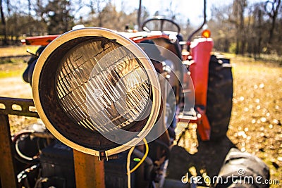 Old orange farm tractor headlight Editorial Stock Photo
