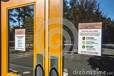 Texas Roadhouse covid-19 warning signs on front door Editorial Stock Photo