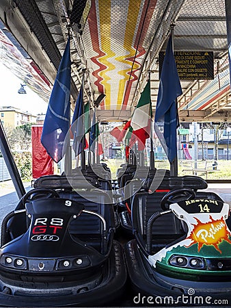 AULLA, ITALY- February 12 2020: Rows of Dodgem aka Bumper Cars parked up in Fun Fair Amusement Park. With Italian flag. Editorial Stock Photo