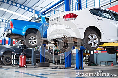 Auomobile repair, Car service centre auto repair with wehicle raised on lift workshop. Car repair service center Stock Photo