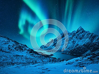 Aurora borealis above the snow covered mountains Stock Photo