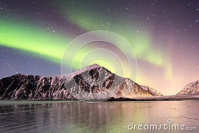 Aurora borealis on the Lofoten islands, Norway. Green northern lights above mountains. Stock Photo
