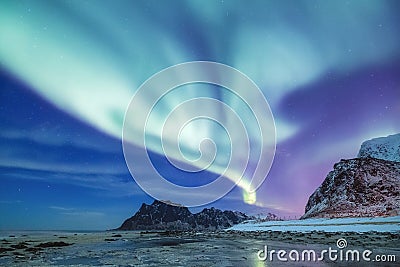 Aurora borealis on the Lofoten islands, Norway. Green northern lights above mountains. Stock Photo