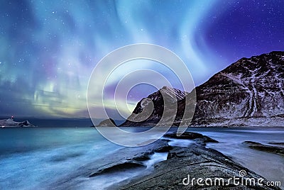 Aurora borealis on the Lofoten islands, Norway. Green northern lights above mountains. Night sky with polar lights. Stock Photo