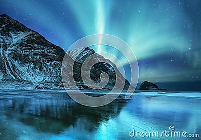 Aurora borealis on the Lofoten islands, Norway. Green northern lights above mountains. Night sky with polar lights. Stock Photo