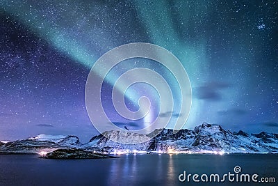 Aurora borealis on the Lofoten islands, Norway. Green northern lights above mountains. Night sky with polar lights. Night winter l Stock Photo