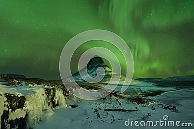 Aurora Borealis the Northern Light at Kirkjufell Iceland. scenic view of waterfall Kirkjufellsfoss aurora polaris in background. Stock Photo